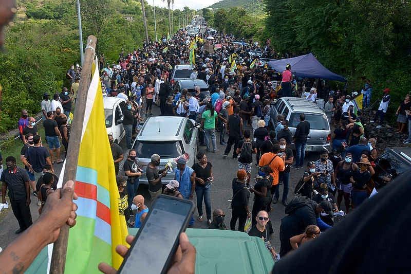 St. Maarten and Saint Martin residents during the unity march, some waving the island's unity flag