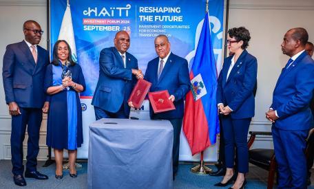 Professor Benedict Oramah, President and Chairman of the Board of Directors of Afreximbank exchanges partnership agreement documents with Honourable Dr. Garry Conille, Prime Minister of the Republic of Haiti (third right). The two leaders were accompanied by senior officials from Afreximbank and the government of Haiti